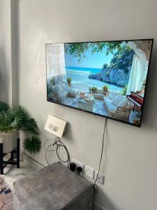 a flat screen tv hanging on a wall at T-Homes in Thika