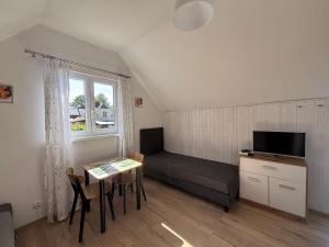 a small living room with a couch and a table at Przy morzu in Jarosławiec