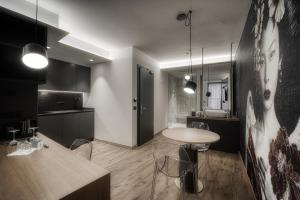 a kitchen with a table and a dining room at M Loft - adults only in Malcesine +26 photos