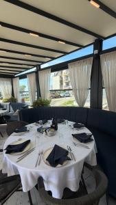 a dining room with a white table with utensils at Family Hotel Trend in Ravda