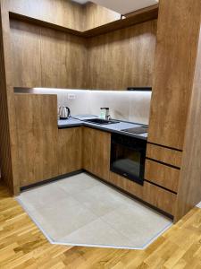 a kitchen with a sink and a stove at Skyline Apartment Skopje in Madžari +3 photos