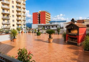 a courtyard with a pizza oven in a city at Midway House Italy in Sant'Egidio del Monte Albino