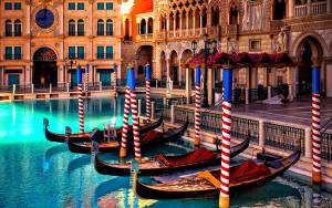 a group of gondolas in the water next to a building at Venice Cappucina Guest House in Mestre
