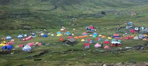 a large group of tents in a field at Selena Camping in Tayapampa