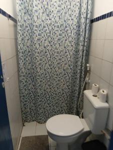 a bathroom with a toilet and a shower curtain at Hostel Republika in Natal +65 photos