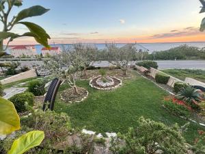 a garden with a view of the ocean at Olivus 3 in Miletići
