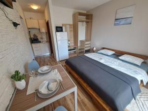 a bedroom with a large bed and a table at Olivus 3 in Miletići