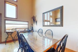 a dining room with a table and chairs and a mirror at Amazing Overlook in McHenry