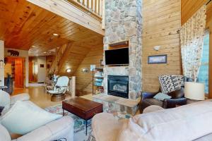a living room with a stone fireplace in a house at Cedar Shores #15 in McHenry