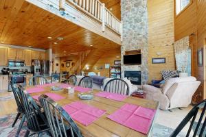 a dining room and living room with a table and chairs at Cedar Shores #15 in McHenry +19 photos