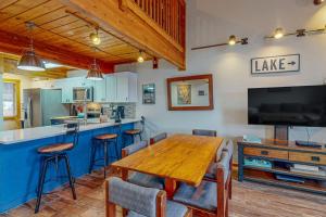 a dining room with a wooden table and a tv at Sans Souci in McHenry