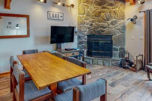 a living room with a wooden table and a fireplace at Sans Souci in McHenry
