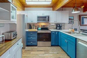 a kitchen with blue cabinets and a sink at Sans Souci in McHenry +13 photos