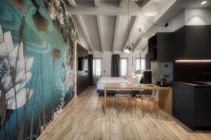 a room with a bed and a table with chairs at M Loft - adults only in Malcesine