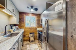 a kitchen with a stainless steel refrigerator and wooden walls at Ski Cove #2 in McHenry +19 photos