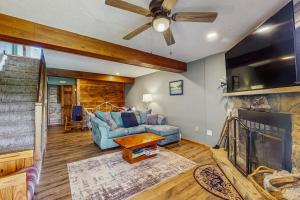 a living room with a blue couch and a fireplace at Ski Cove #2 in McHenry
