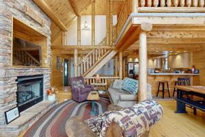 a living room with a fireplace in a log cabin at 5 Little Acorns in McHenry