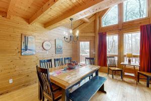 a dining room with a large wooden table and chairs at 5 Little Acorns in McHenry