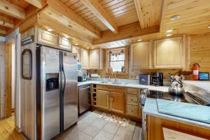 a kitchen with a stainless steel refrigerator and wooden cabinets at 5 Little Acorns in McHenry +30 photos