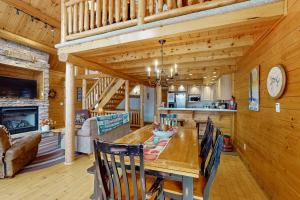 a dining room and kitchen with a table and chairs at 5 Little Acorns in McHenry