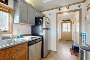 a kitchen with a sink and a refrigerator at Nimba Cabin in Oakland
