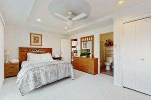 a bedroom with a bed and a ceiling fan at Nimba Cabin in Oakland