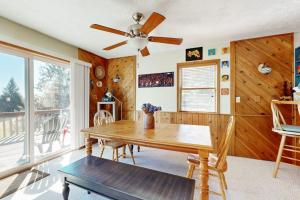 a dining room with a table and a ceiling fan at Nimba Cabin in Oakland