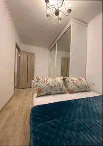 a bedroom with a bed with a large mirror at Центр Пассаж ЦУМ in Dnipro