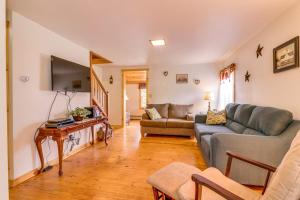 a living room with a couch and a tv at Still Meadows in Oakland