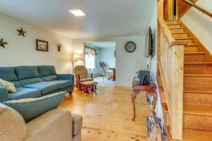 a living room with a blue couch and a staircase at Still Meadows in Oakland