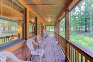 a porch with chairs and windows on a house at Lazy Bear Lodge in Swanton