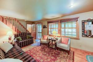 a living room with a couch and chairs and a staircase at Lazy Bear Lodge in Swanton