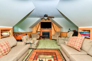 a living room with couches and a flat screen tv at Lazy Bear Lodge in Swanton +30 photos