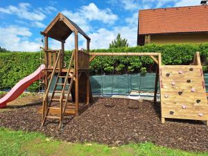 a playground with a slide and a climbing frame at Vila Hafira in Zuberec