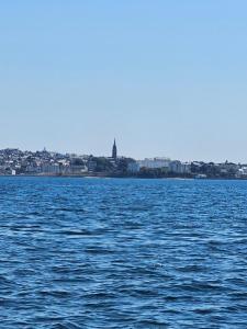 a large body of water with a city in the background at les Arômes in Locronan