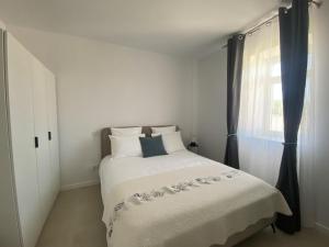 a bedroom with a bed and a window at Casa Fonte Nova in Covões +11 photos