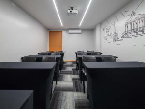 an empty room with rows of chairs and a door at ibis Styles Belém do Pará in Belém