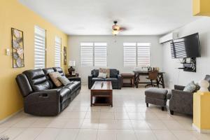 a living room with couches and a tv at Villa del Enseuno- Pristine View and Infinity Pool in Luquillo +53 photos