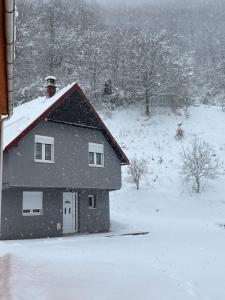 a house with snow on the roof of it at Rakocevic house in Kolašin