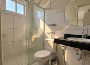 a white bathroom with a toilet and a sink at Apartamento Moto Chico Petrolina in Petrolina