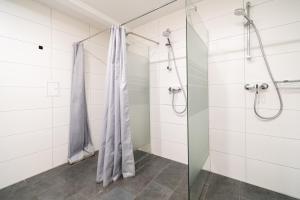a bathroom with a shower and a glass door at D10 I shared bathrooms&kitchen in Garching bei München +46 photos