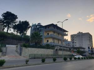 a building on the side of a city street at Qiqi Hotel in Gjirokastër