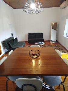 a living room with a wooden table and chairs at Αιθεροβάμων - Etherovamon in Areopoli