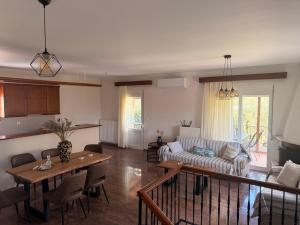 a living room with a couch and a table at Olea House in Alexandroupoli