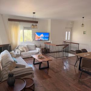 a living room with a couch and a table at Olea House in Alexandroupoli