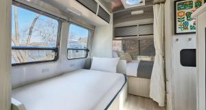 a small room with two beds and a window at AutoCamp Asheville in Asheville +79 photos