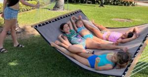 a group of girls laying on a hammock at Dual En-Suite Corner Unit - Sunrise Views in Fort Pierce