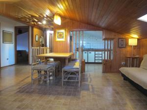 a living room with a table and chairs and a couch at Ático Yuly in Rianjo