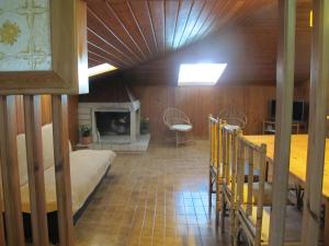 a large room with a bed and a fireplace at Ático Yuly in Rianjo