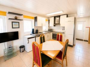 a kitchen with a wooden table and a dining room at Stadldorf» Ferienwohnung Wagner in Kirchroth